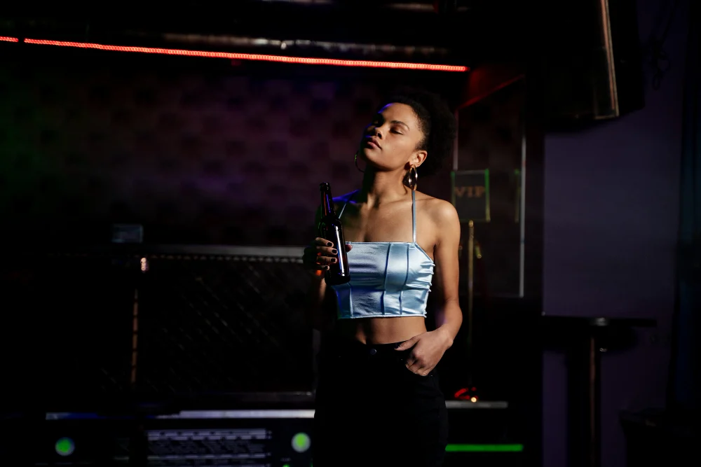 image of a woman taking dark and moody silhouette boudoir photoshoot